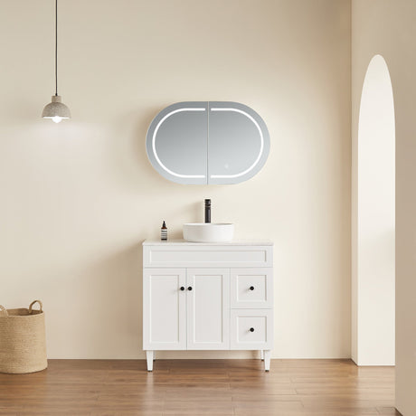 Bathroom vanity with a mirror and sink against a beige wall.
