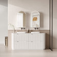 Bathroom vanity with two sinks, mirrors, and decorative elements.
