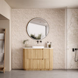 Bathroom with wooden vanity, round mirror, and tiled walls.