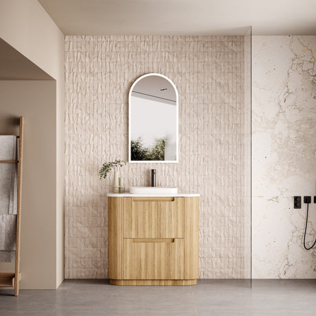 Bathroom with wooden vanity, mirror, and decorative elements.