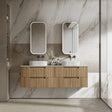 Bathroom vanity with wooden cabinet, two sinks, and mirrors against a marble wall.