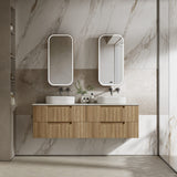 Bathroom vanity with wooden cabinet, two sinks, and mirrors against a marble wall.