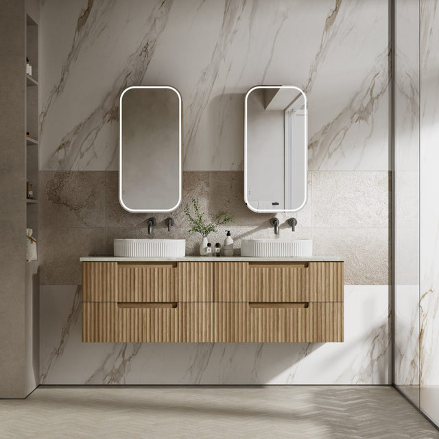 Bathroom vanity with wooden cabinet, two sinks, and mirrors against a marble wall.