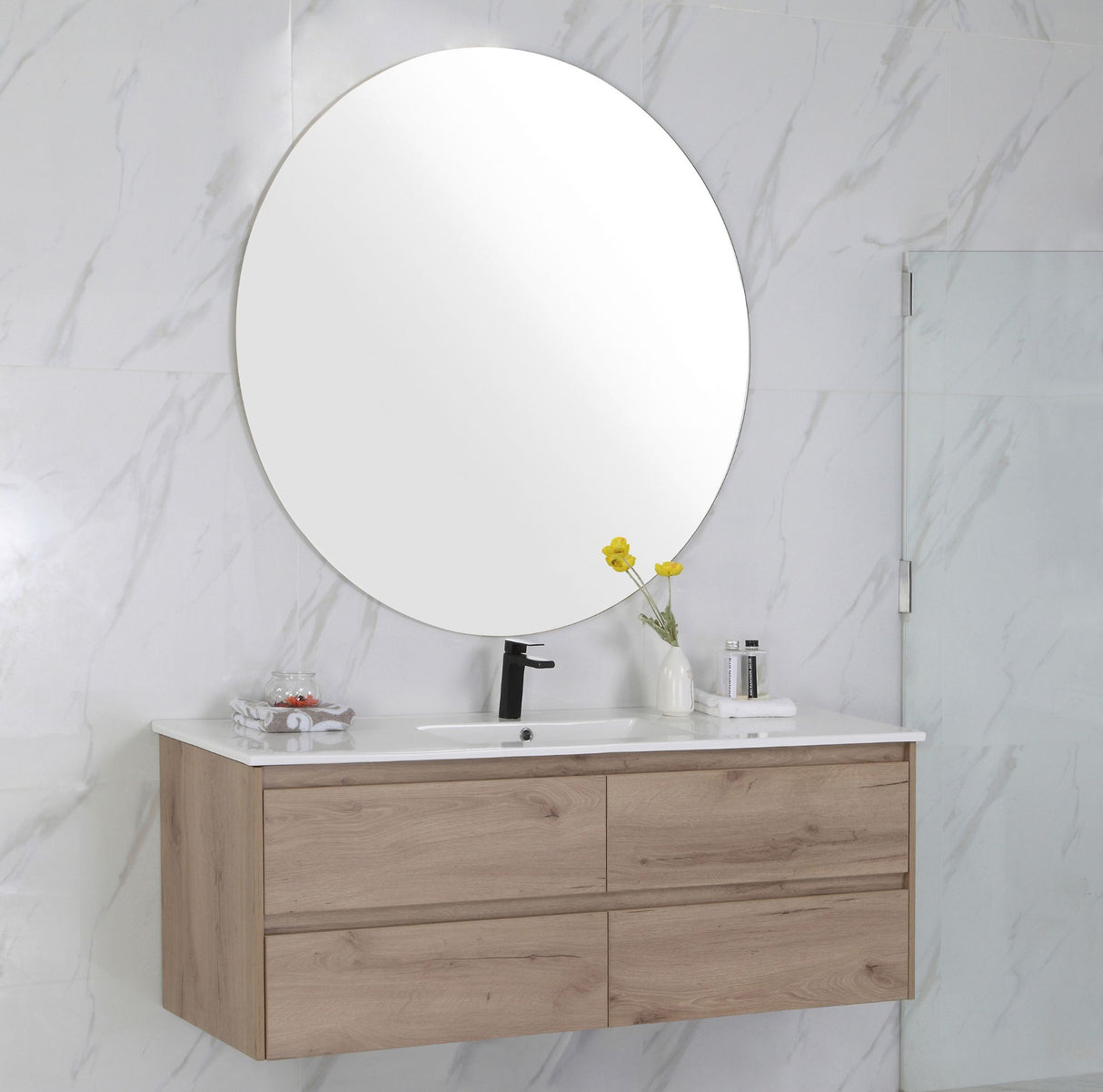 Bathroom vanity with wooden cabinet, round mirror, and marble wall.