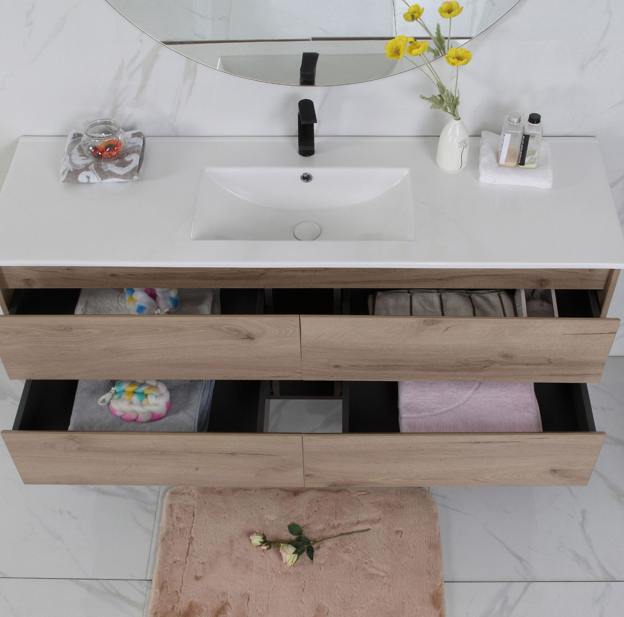 Bathroom vanity with white countertop, wooden drawers, and mirror.