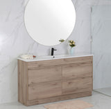 Bathroom vanity with wooden finish and round mirror in a marble bathroom setting