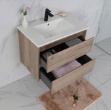 Bathroom vanity with open drawer, white countertop, and marble floor.