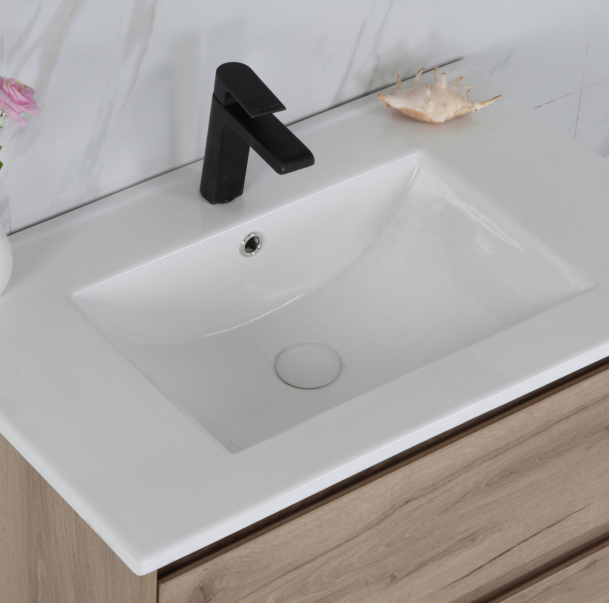 Bathroom sink with black faucet on a wooden vanity
