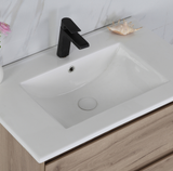 Bathroom sink with black faucet on a wooden vanity