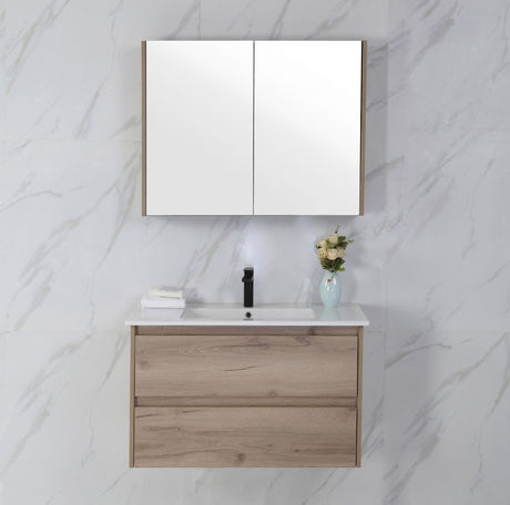 Bathroom vanity with wooden cabinet, white countertop, and mirror on a marble wall.