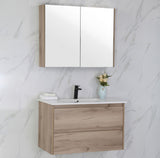 Bathroom vanity with mirror cabinet against a marble wall.