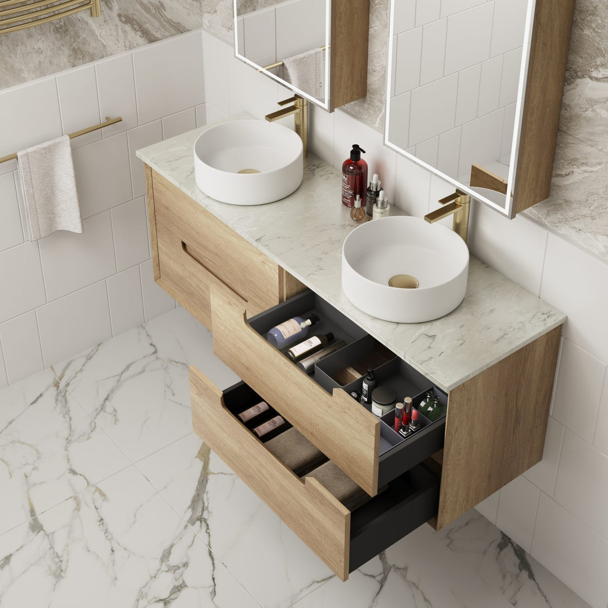 Bathroom vanity with two white sinks, wooden cabinets, and open drawers.