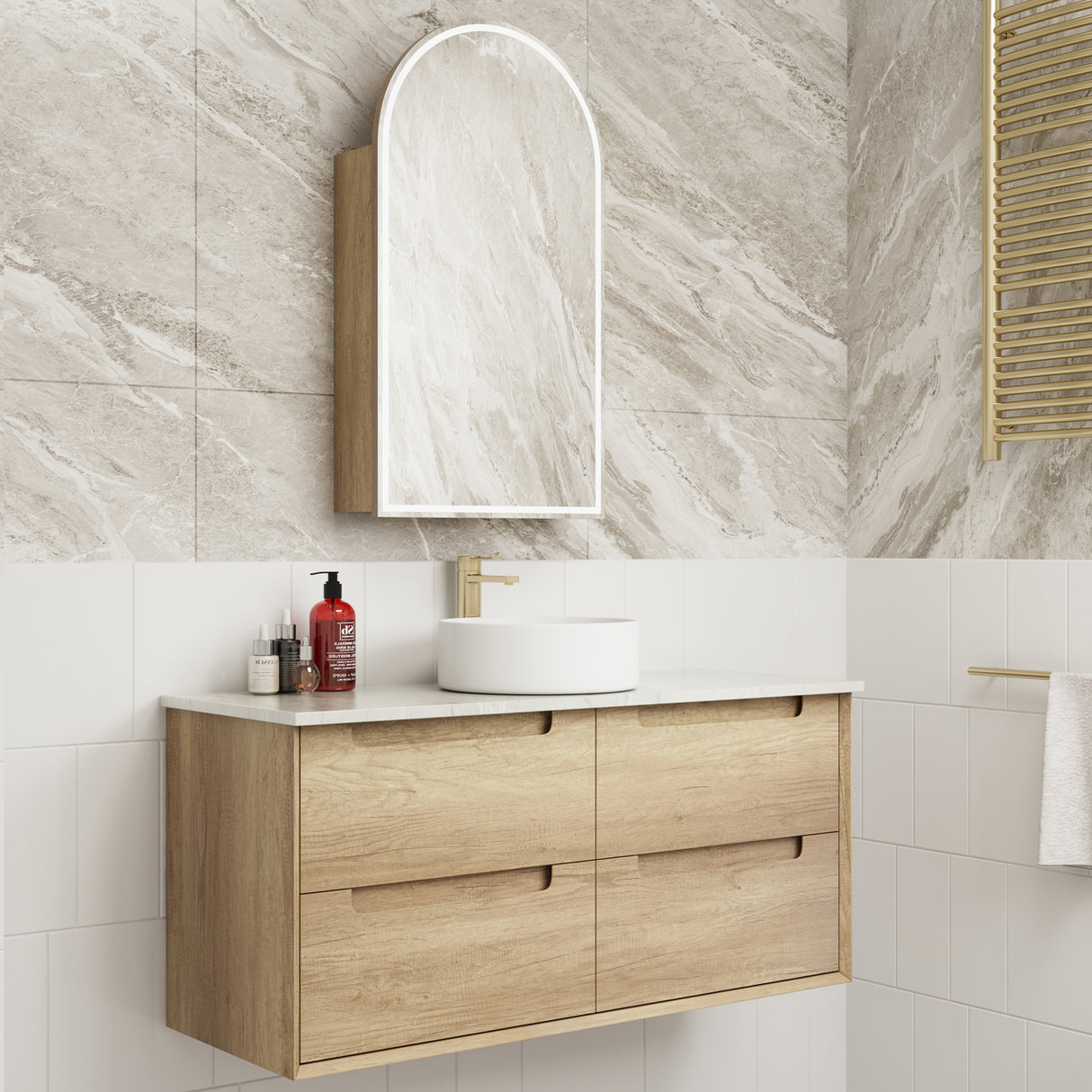 Bathroom vanity with wooden cabinet, white countertop, and mirror against a tiled wall.