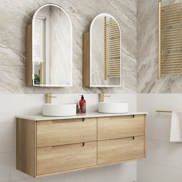 Bathroom vanity with double sink, mirrors, and decorative elements.