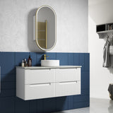 Bathroom vanity with sink, mirror, and decorative elements against a blue and gray wall.