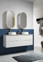 Bathroom with white vanity, two sinks, and oval mirrors against a blue tiled wall.