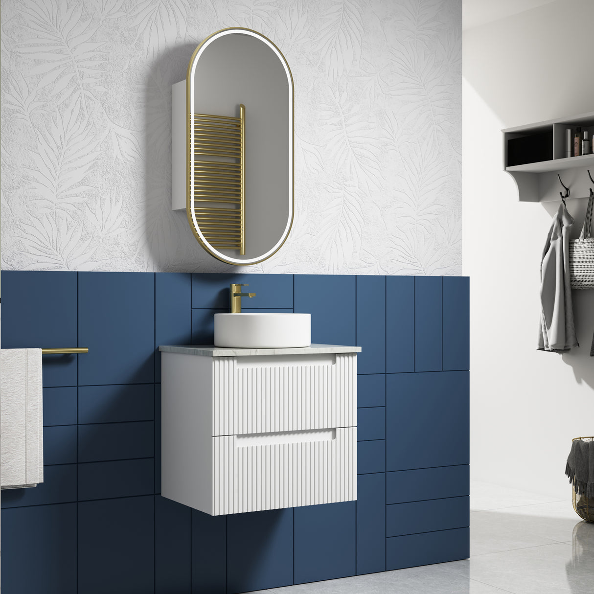 Bathroom setup with white vanity, round mirror, and blue tiled wall.