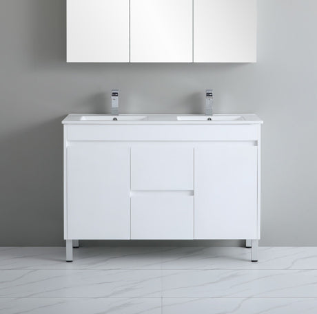 White bathroom vanity with two sinks against a gray wall.