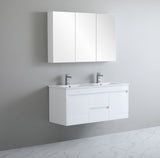 Bathroom vanity with white cabinets and sink against a gray wall.