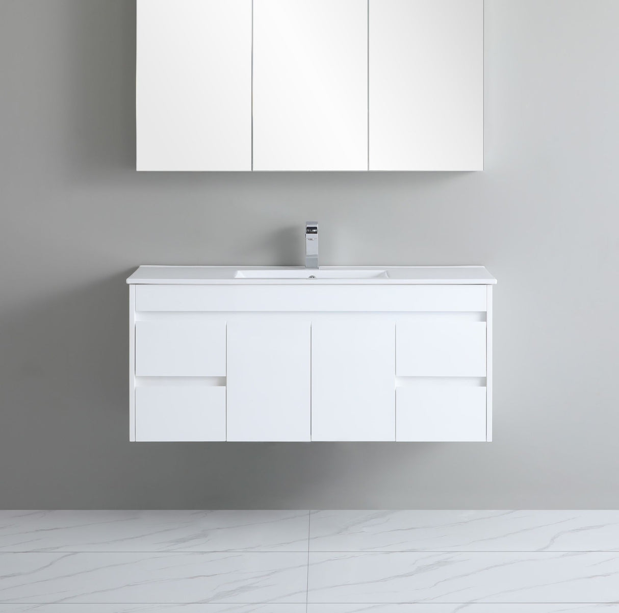 White bathroom vanity with sink and cabinets on a gray wall.