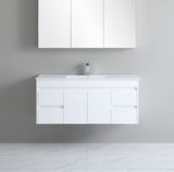 White bathroom vanity with sink and cabinets on a gray wall.
