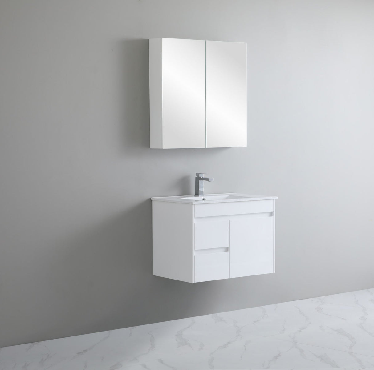 Bathroom setup with white vanity unit and mirror cabinet against a gray wall.