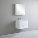 Bathroom setup with white vanity unit and mirror cabinet against a gray wall.