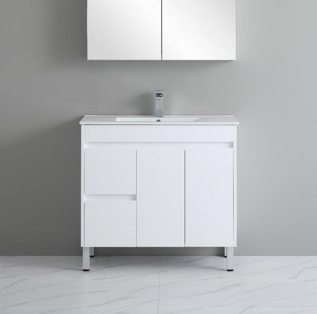 White bathroom vanity with sink against a gray wall