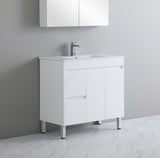 White bathroom vanity with sink against a gray wall