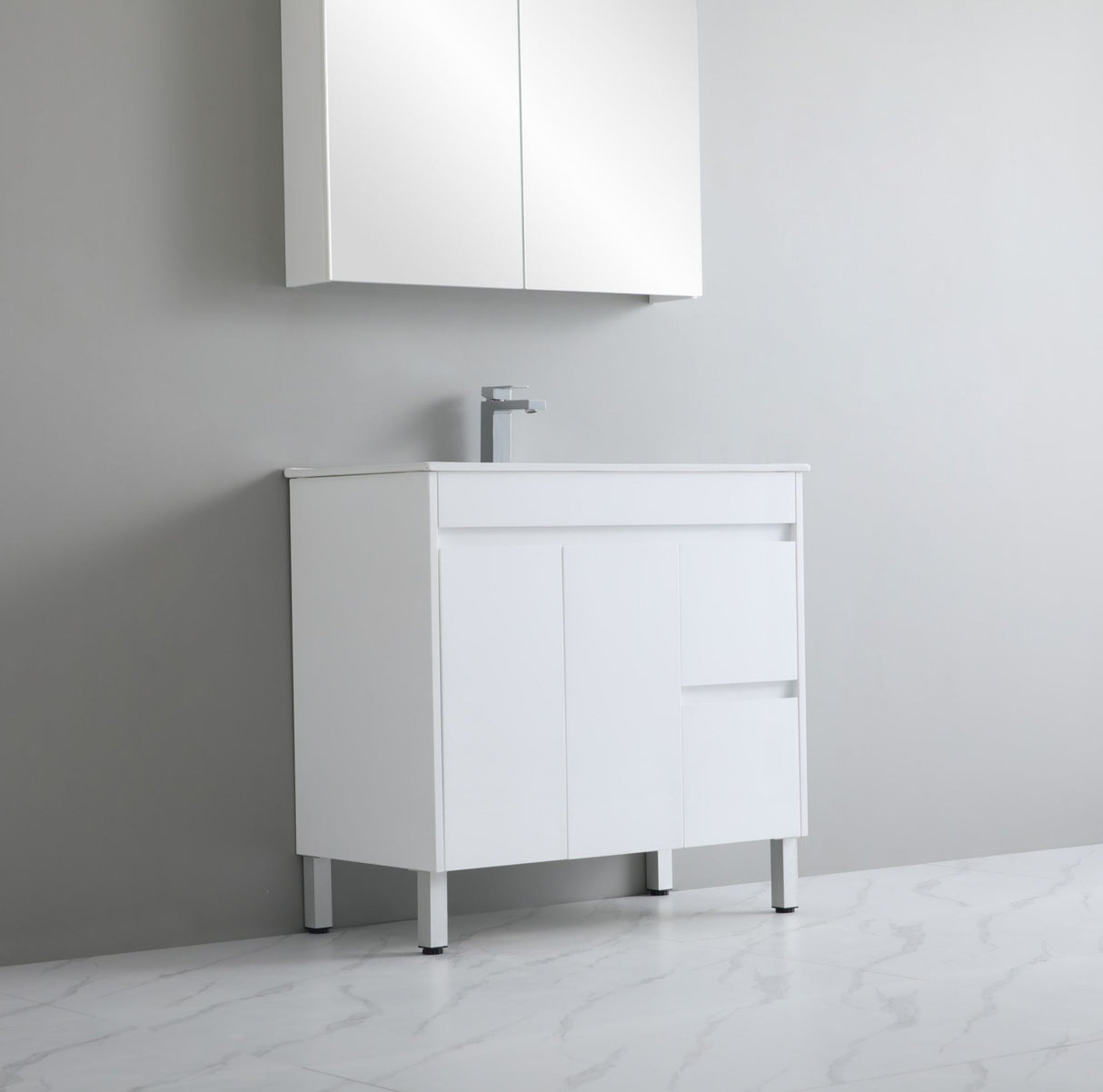 White bathroom vanity with sink against a gray wall