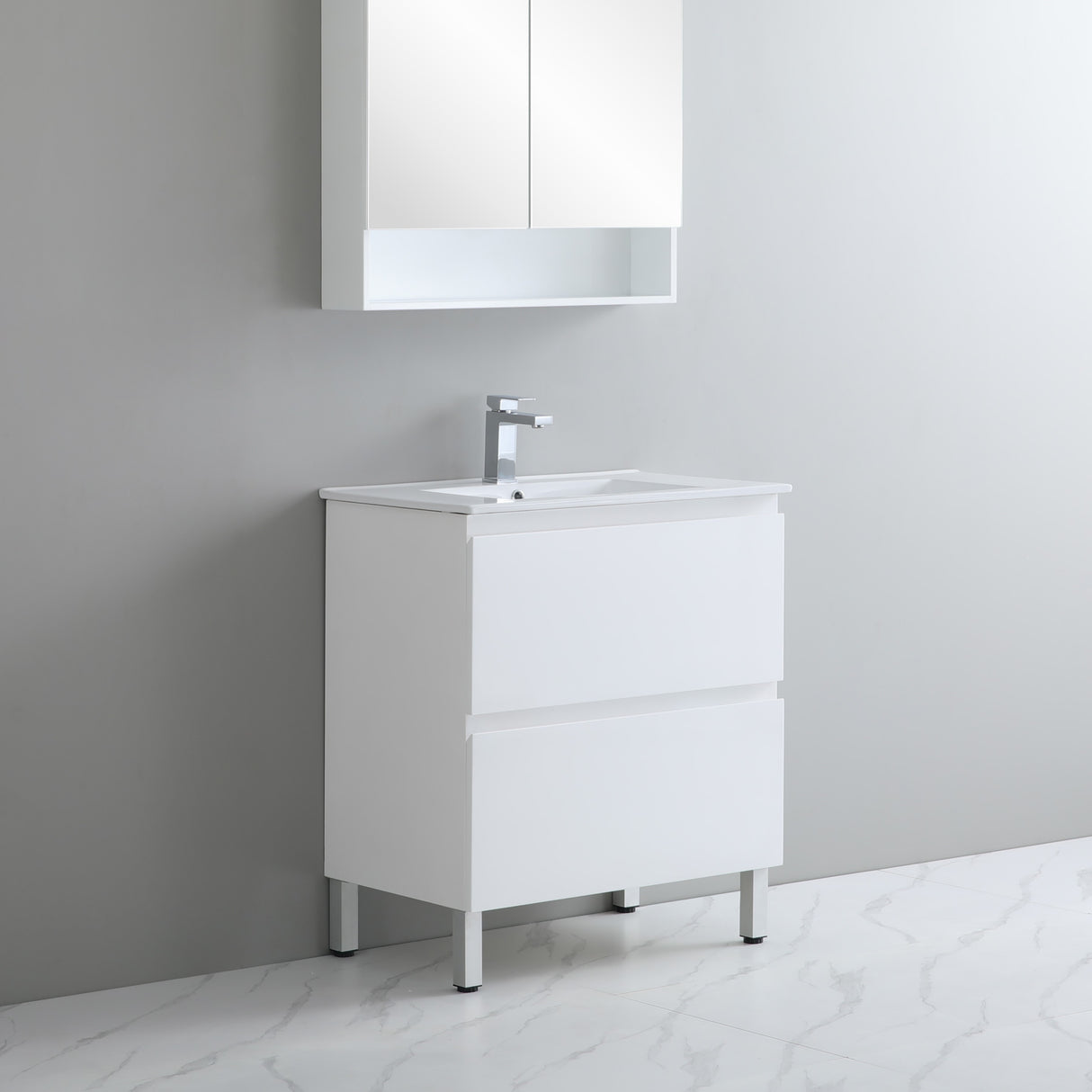 White bathroom vanity with sink and mirror cabinet against a gray wall.