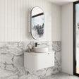Modern bathroom with white vanity, round mirror, and marble-patterned wall.