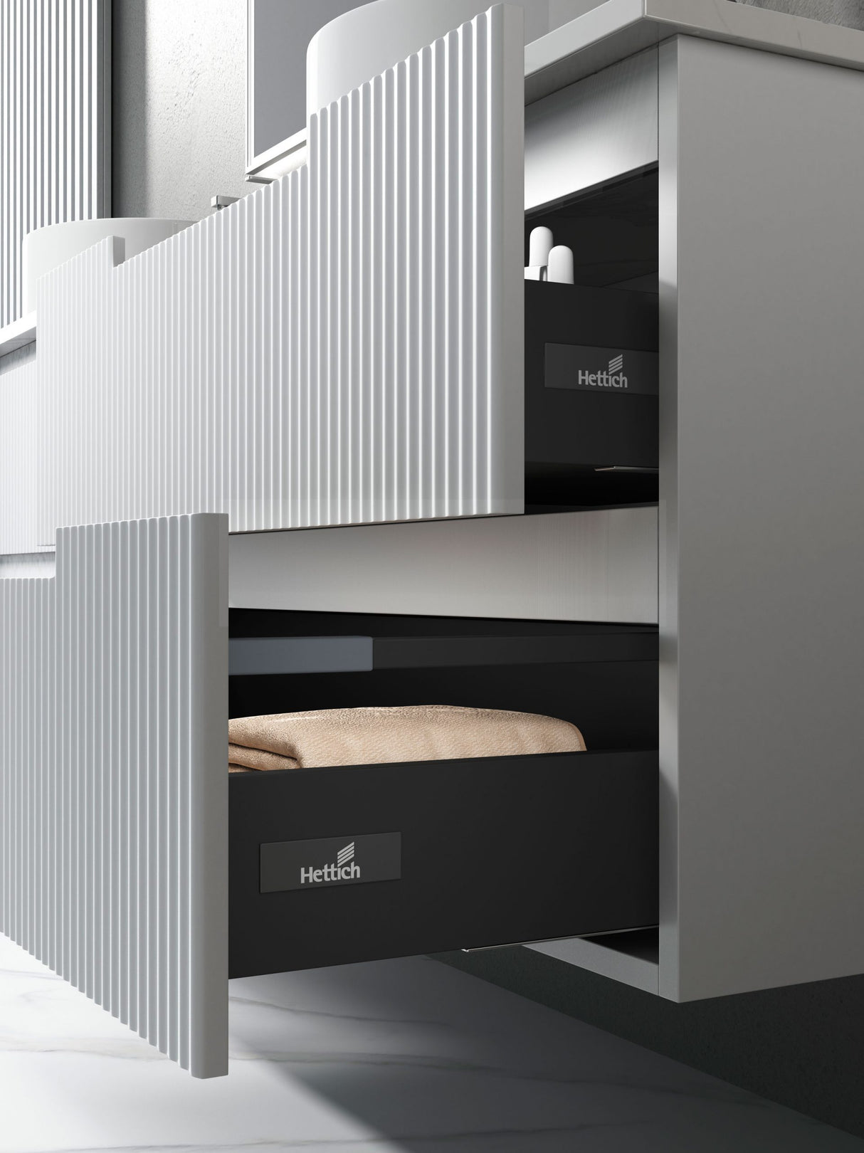 Modern kitchen cabinet with open drawer displaying Hettich branding.