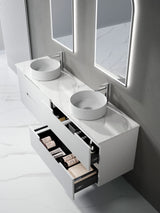 Bathroom vanity with two round sinks and an open drawer displaying toiletries.