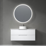 Bathroom vanity with round illuminated mirror on a gray wall