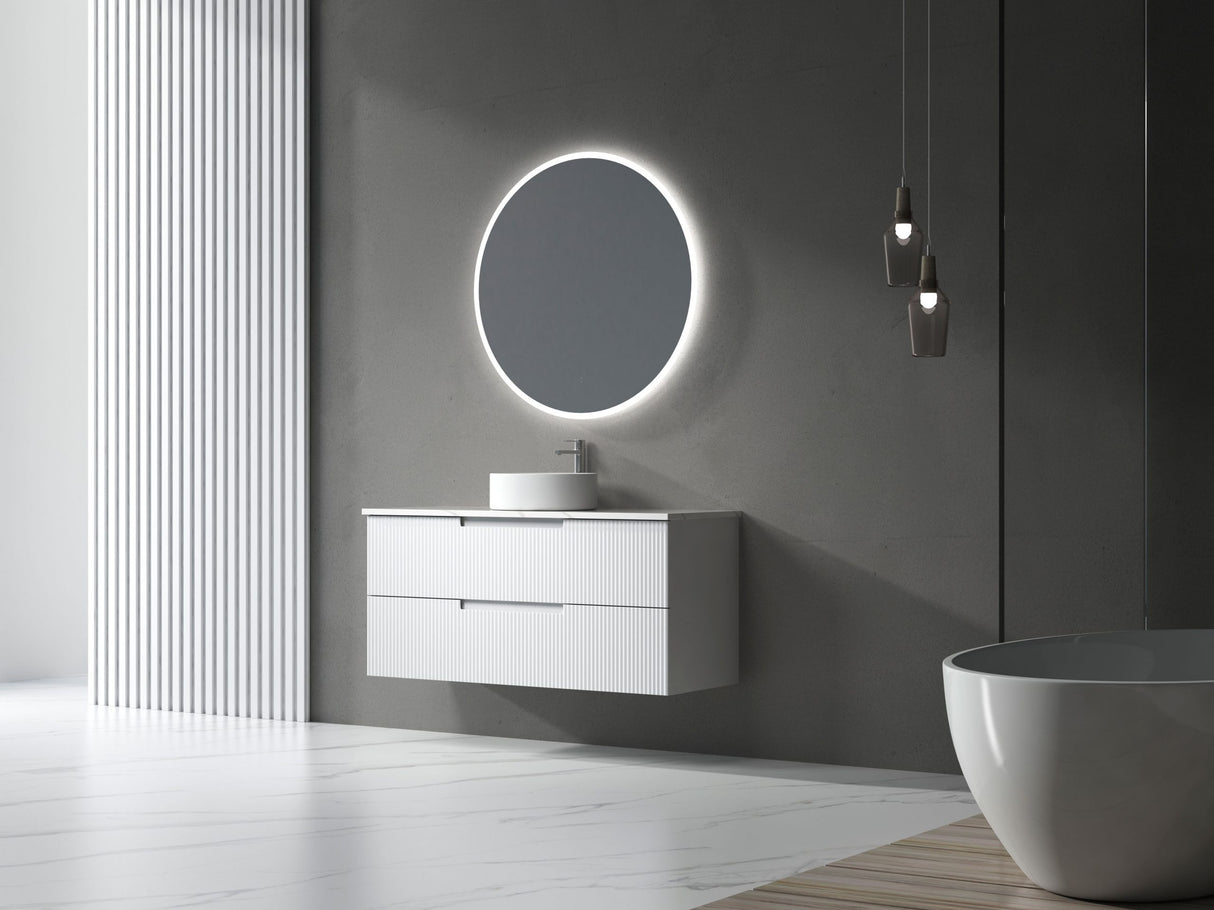 Modern bathroom with a round illuminated mirror and white vanity.
