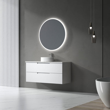 Modern bathroom with a round illuminated mirror and white vanity.