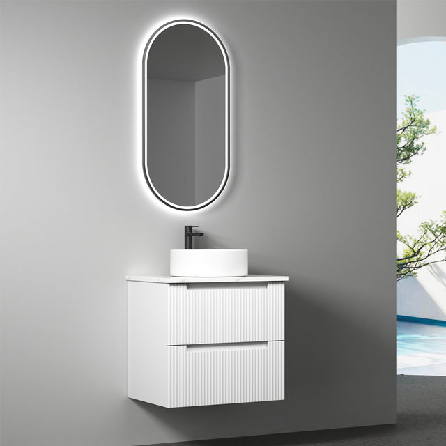 Bathroom vanity with sink and mirror on a gray wall