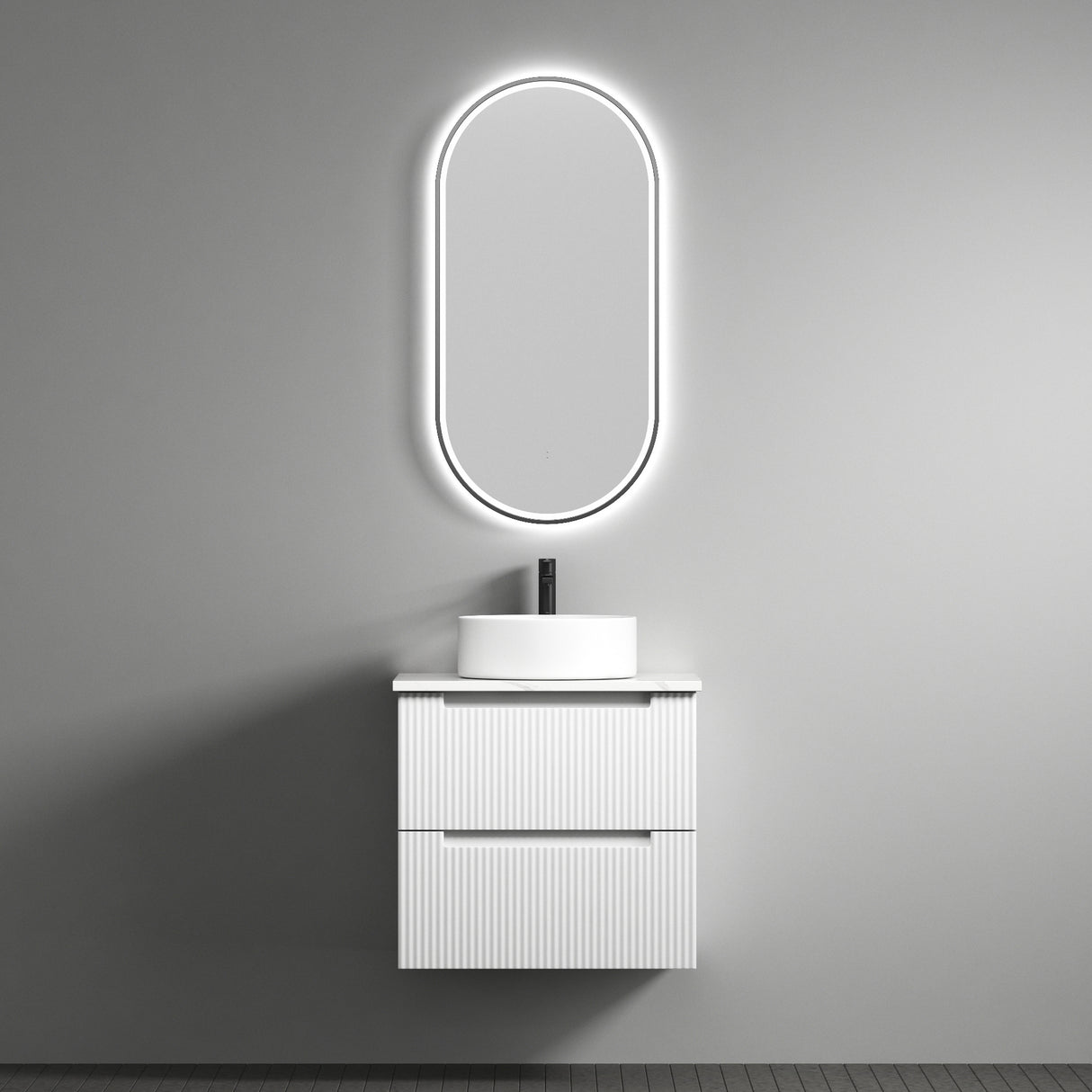 Bathroom vanity with illuminated oval mirror against a gray wall