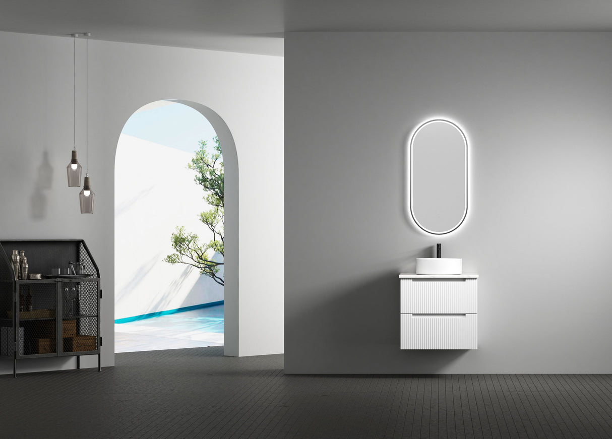 Modern bathroom with a vanity unit and illuminated mirror.