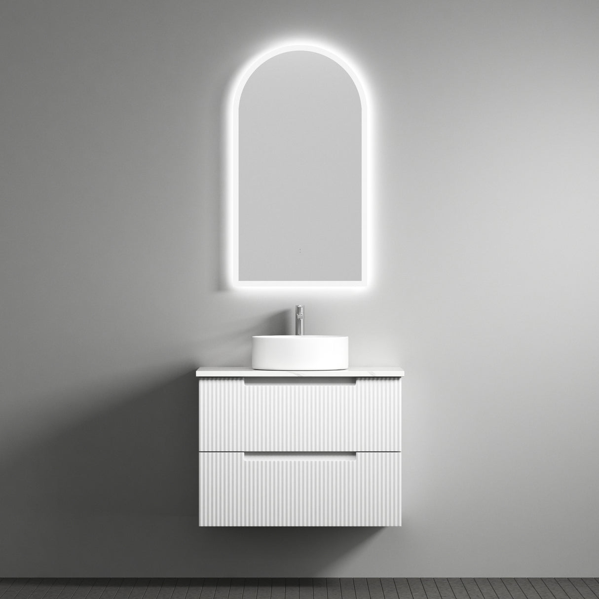Bathroom vanity with illuminated mirror against a gray wall