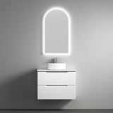 Bathroom vanity with illuminated mirror against a gray wall