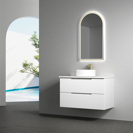 Bathroom vanity with illuminated mirror and sink in a modern setting.