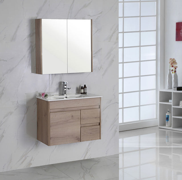 Bathroom vanity left hand drawer with mirror cabinet against a marble wall.