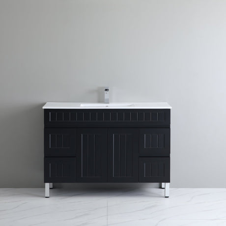 Black bathroom vanity with white countertop against a gray wall