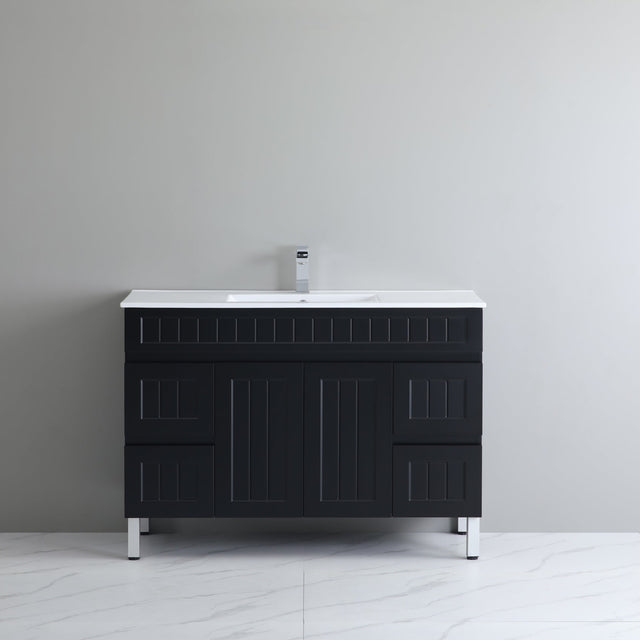 Black bathroom vanity with white countertop against a gray wall
