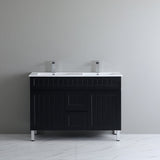 Black bathroom vanity with white countertop against a gray wall
