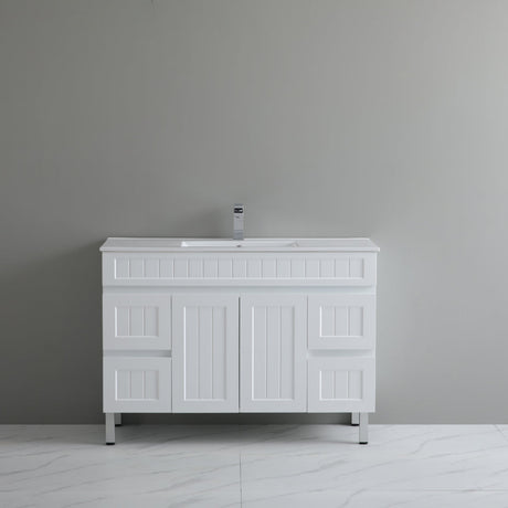 White bathroom vanity with sink against a gray wall