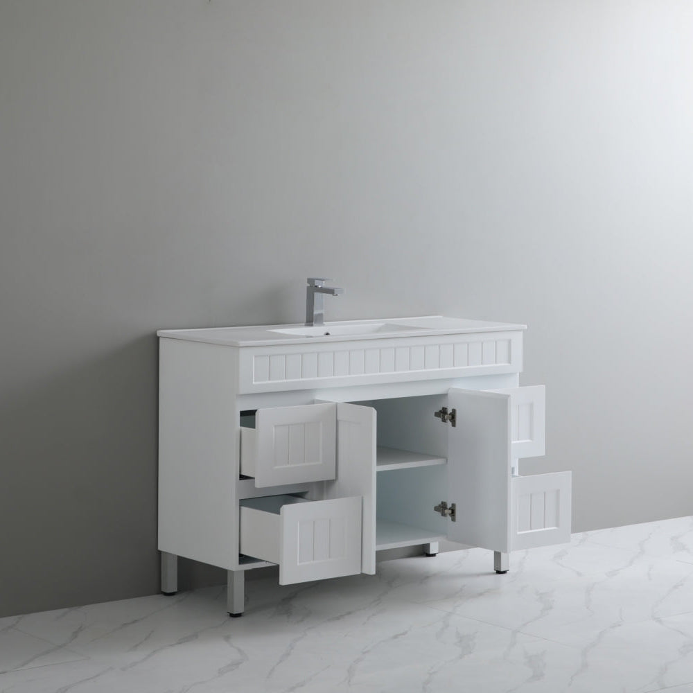 White bathroom vanity with sink against a gray wall