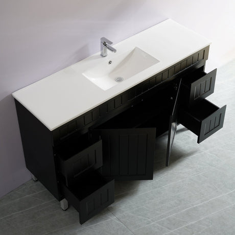 Bathroom vanity with white countertop and black cabinets against a gray wall.